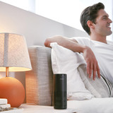 Black | Man relaxes on couch with the Homedics TotalClean 4-IN-1 UV Portable Air Purifier in black on end table