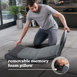 Man unfolds the Homedics Body Flex Back Stretching Mat with Heat on floor