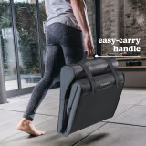 Woman carries folded Homedics Body Flex Back Stretching Mat with Heat