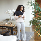 Woman standing with the Homedics 12" x 24" Weighted Gel Heating Pad draped across right shoulder