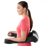 Standing woman receives lower back massage from the Homedics "Thumbs up" Cordless 3D Kneading Massager with Soothing Heat