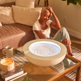 21-inch, black | woman sits on floor practicing mindful meditation as she gazes into the drift sandscape sand table on the coffee table