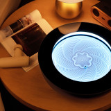 16-inch, cream | drift sandscape sand table sits on a nightstand with a magazine, massage gun, and House of Marley speaker next to it