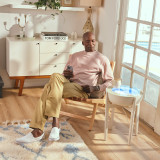 White Wash | drift 21" wood stand displays the drift sand table next to a man while he relaxes in the afternoon