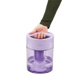 Lilac | Customer grabbing handle of the Homedics TotalComfort UV-C Ultrasonic Humidifier